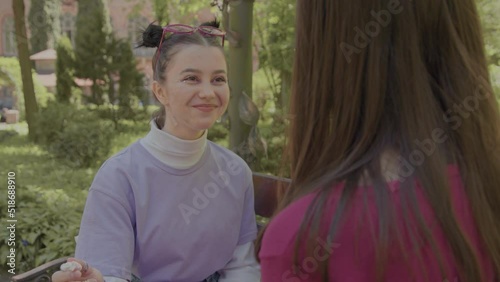 The girls eat marshmallows together and look at each other in love. Childish infatuation of two girls.