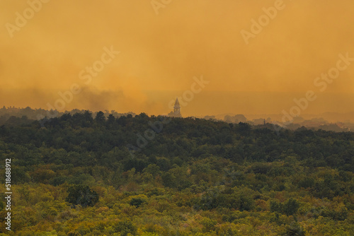 Karst, Miren-Kostanjevica, Slovenia - July 22, 2022: 
A large forest fire in the Karst. It is fought by firefighters on the ground and military and police helicopters from the air.