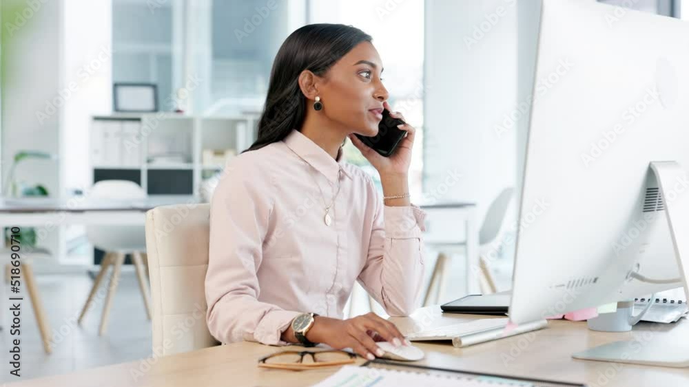 Young business woman talking on a phone while working on her computer in the office. Trendy marketing professional discussing project ideas or deadlines on a call with her boss, manager or supervisor Young business woman talking on a phone while working on her computer in the office. Trendy marketing professional discussing project ideas or deadlines on a call with her boss, manager or supervisor