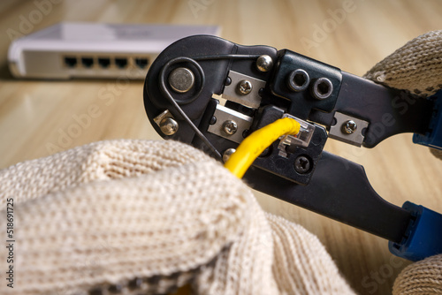 Bilde på lerret gloved hand putting together a network connector with crimping tool