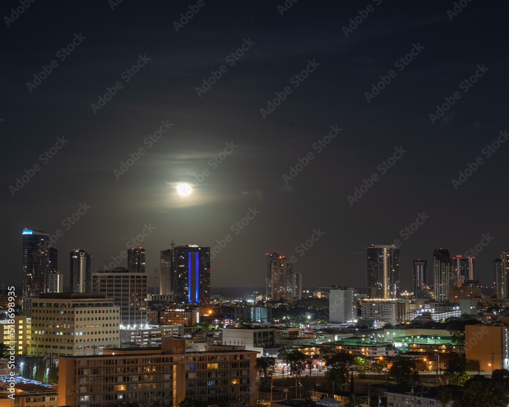 Moon Over a City at Night.