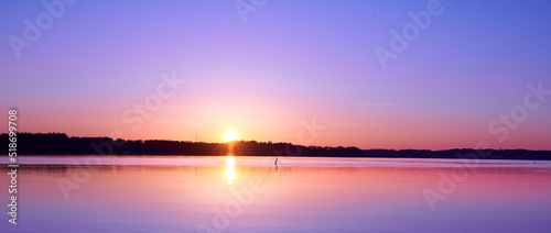Beautiful sunset view of an empty beach and mountains in the background outdoors. Relaxing ocean setting in the early evening. A colorful natural sea landscape with a mountain silhouette in summer.