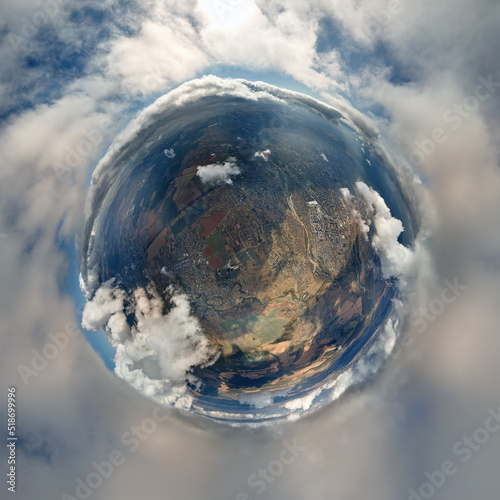 Photography Aerial view from high altitude of little planet earth covered with white puffy c