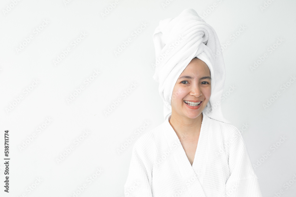 Beautiful Asian woman wearing bathrobe on white background, Face care, Skin care, Facial treatment, Cosmetology, beauty and spa Concept. Beautiful Asian woman wearing bathrobe on white background, Face care, Skin care, Facial treatment, Cosmetology, beauty and spa Concept.