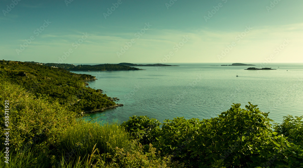 Sea landscape, islands in the horizon, a long coastline covered with vegetation