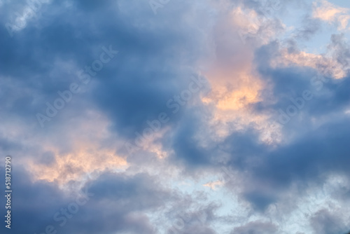 Sky background with sunlight through clouds at sunset