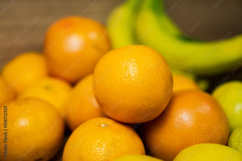 Orange on a bed of fruits and vegetables Orange on a bed of fruits and vegetables
