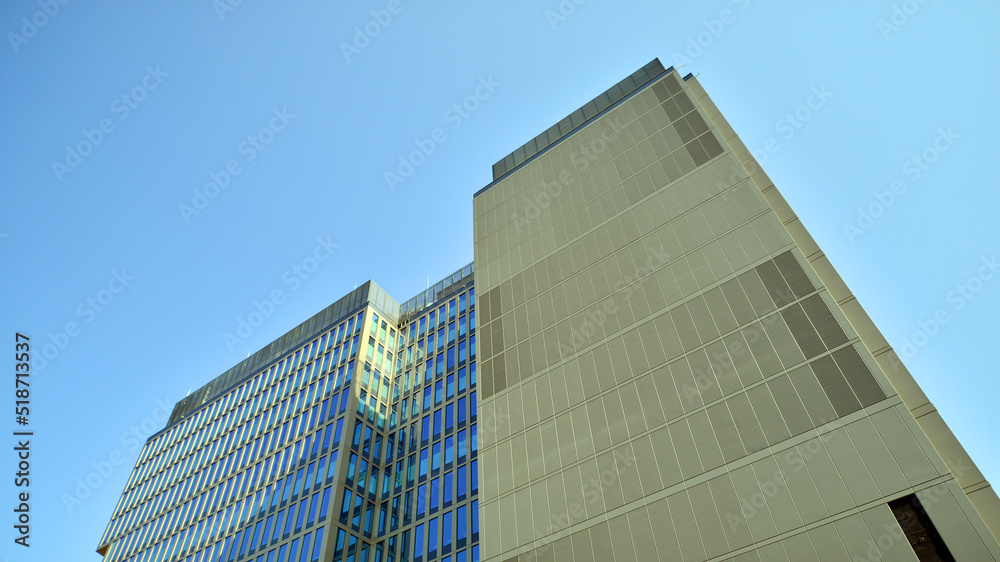 Business office building in the blue sky background. Tall building in the center of the city. Business office building in the blue sky background. Tall building in the center of the city.