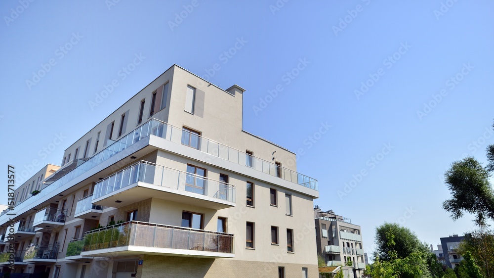 Exterior of new apartment buildings on a blue cloudy sky background. No people. Real estate business concept. Exterior of new apartment buildings on a blue cloudy sky background. No people. Real estate business concept.