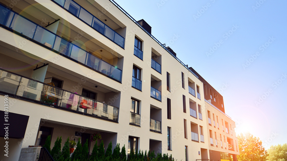 Exterior of new apartment buildings on a blue cloudy sky background. No people. Real estate business concept. Exterior of new apartment buildings on a blue cloudy sky background. No people. Real estate business concept.