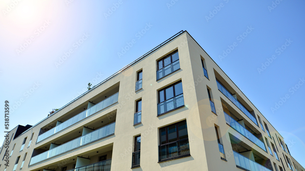 Exterior of new apartment buildings on a blue cloudy sky background. No people. Real estate business concept.