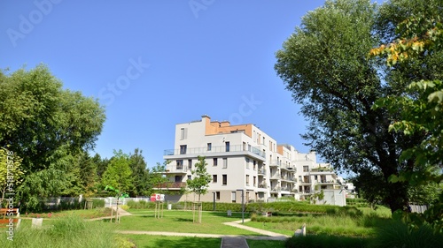 Exterior of new apartment buildings on a blue cloudy sky background. No people. Real estate business concept.