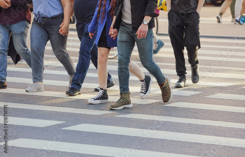 People in the city cross the road on a zebra