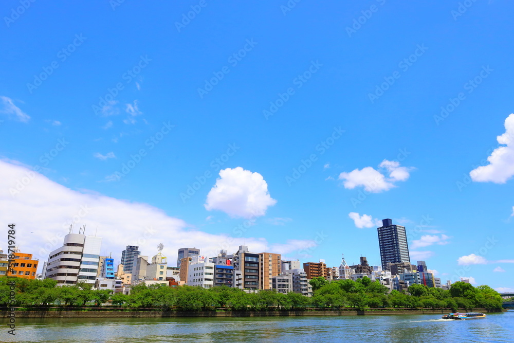 Fototapeta premium city skyline with clouds and river