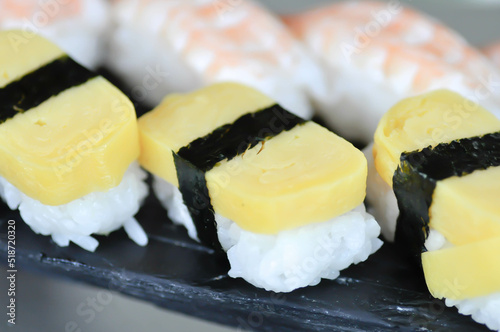 sushi or egg sushi , rice topped with egg and shrimp sushi or steam egg roll
