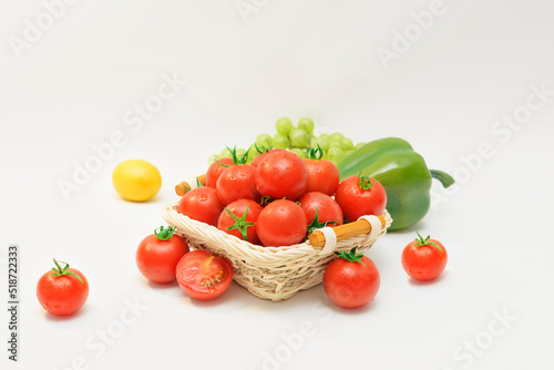 Fototapeta Naklejka Na Ścianę i Meble -  the cherry tomatos put in basket and lemon, green pepper 