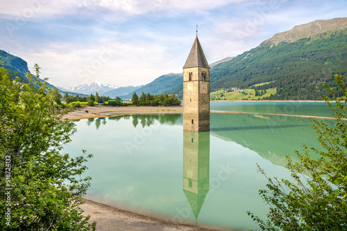View at the Bell tower jutting out of Lake Resia in Curon Venosta, Italy