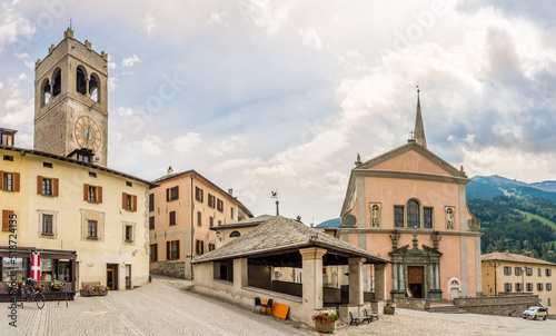 View at the Bajona Clock tower and Saints Gervasio and Protasio at Cavour place in Bormio, Italy photo