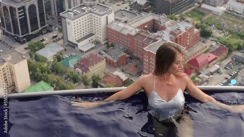 Attractive woman in swimming pool on roof