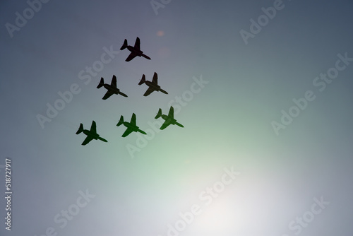 Acrobatic fighter silhouette in flight