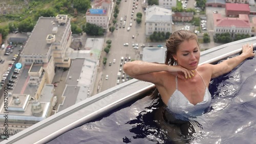 Attractive woman in swimming pool on roof
