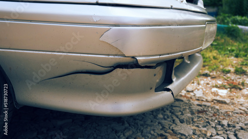 A broken bumper in the car, an accident, a breakdown and a cracked bumper. Plastic element of the car. Selective focus