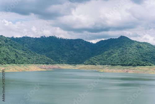 Beautiful view water in lake and high mountain with blue cloudy sky behind