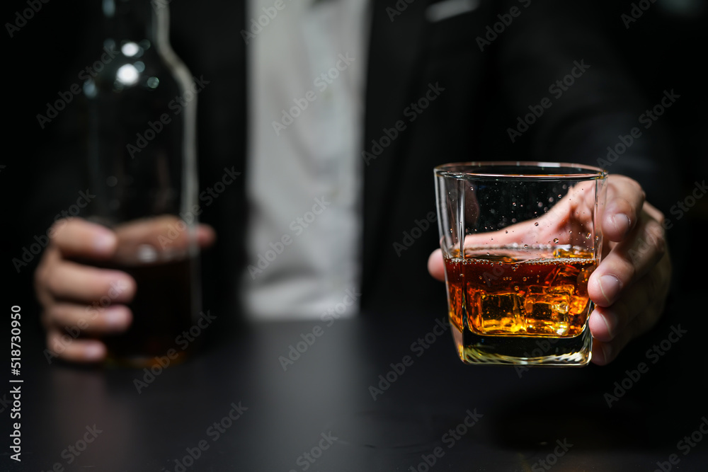 Closeup businessmen holding a glass of whiskey Closeup businessmen holding a glass of whiskey
