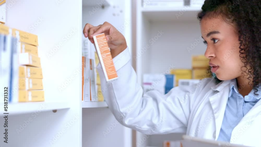 Female chemist or pharmacist organizing the shelves at a pharmacy while using a digital tablet alone at work. One young and serious black woman and chemist doing stock take with medicine at a clinic Female chemist or pharmacist organizing the shelves at a pharmacy while using a digital tablet alone at work. One young and serious black woman and chemist doing stock take with medicine at a clinic