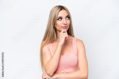 Pretty blonde woman isolated on white background thinking an idea while looking up