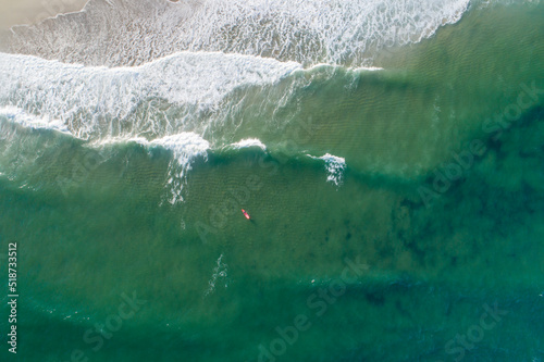 Aerial view at the beach surfer waiting for the good wave. Beautiful natural seascape at the summer time