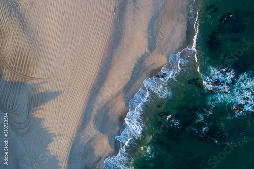 Drone aerial view of a beach at sunrise, summer landscape concept © Vic