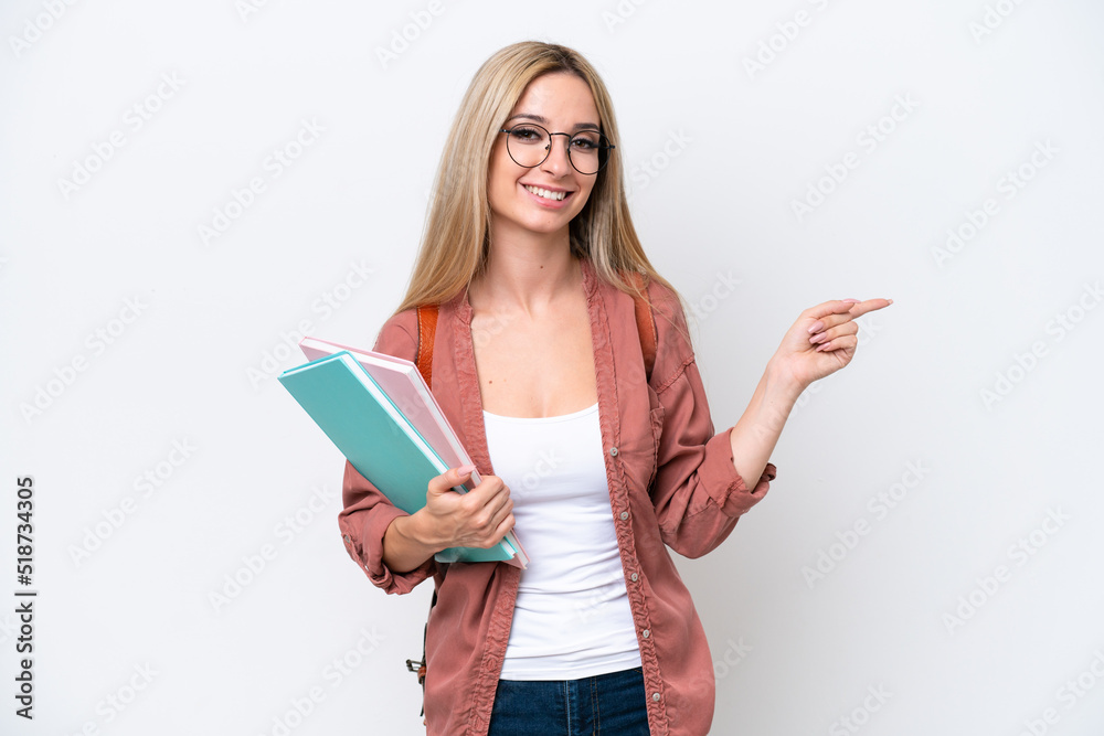 Pretty student blonde woman isolated on white background pointing finger to the side Pretty student blonde woman isolated on white background pointing finger to the side