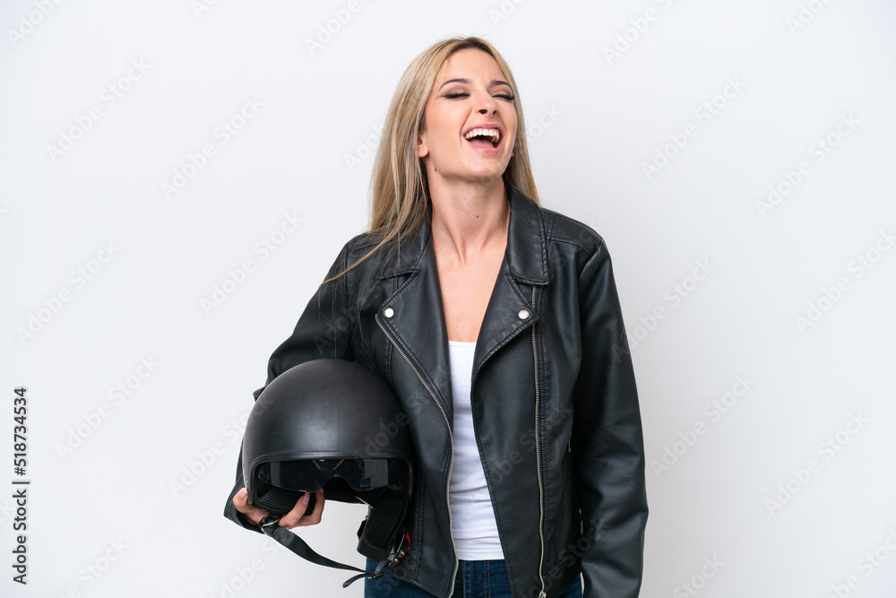 Pretty blonde woman with a motorcycle helmet isolated on white background laughing Pretty blonde woman with a motorcycle helmet isolated on white background laughing