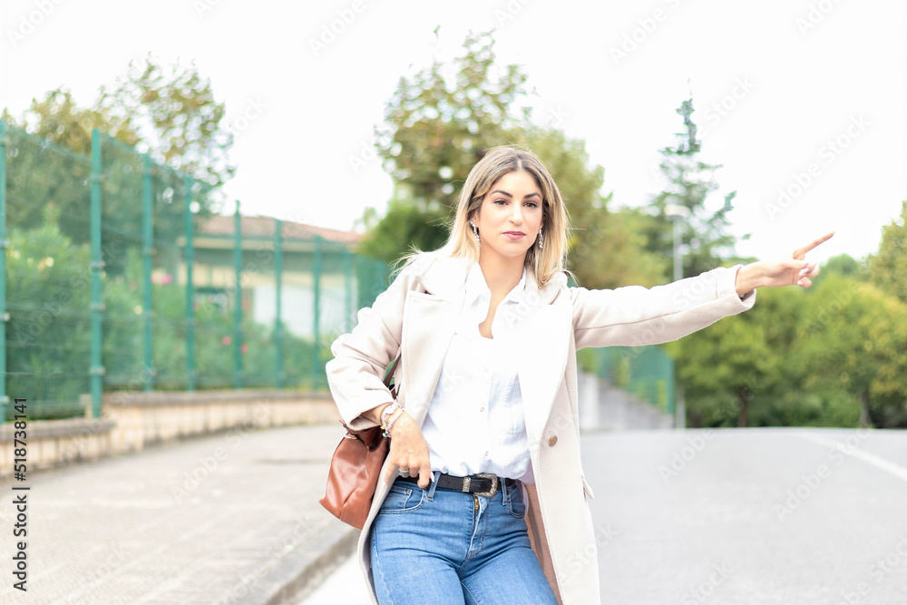 business woman stopping a taxi with big gestures