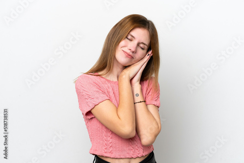 Young English woman isolated on white background making sleep gesture in dorable expression