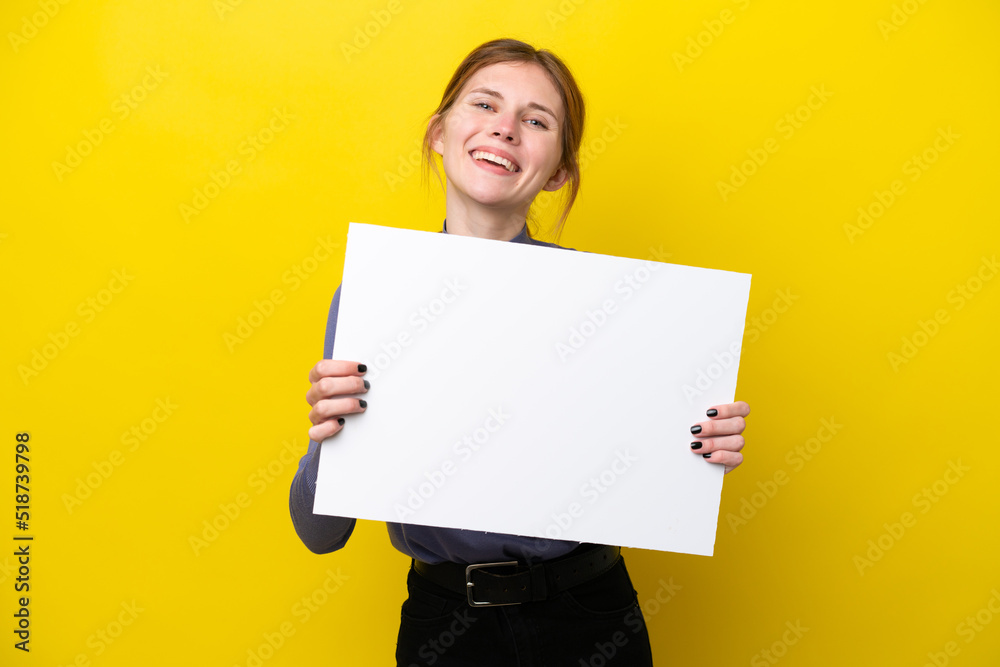 Young English woman isolated on yellow background holding an empty placard with happy expression Young English woman isolated on yellow background holding an empty placard with happy expression