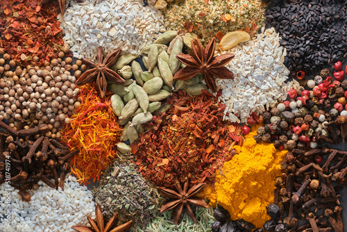 Fototapeta Naklejka Na Ścianę i Meble -  Spices. Aromatic Indian spices on a slate background. Spices and herbs