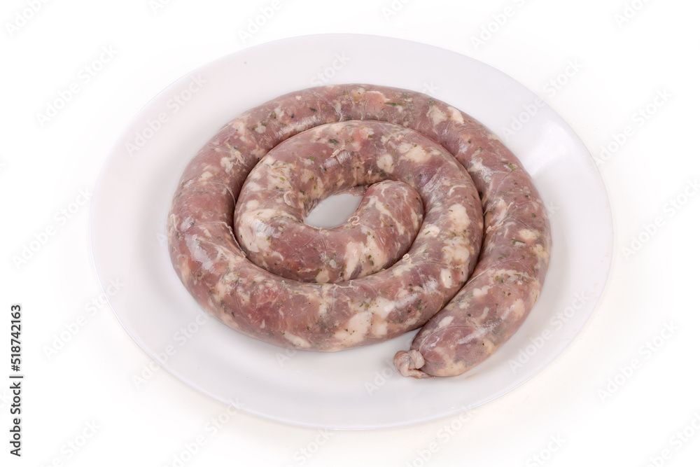 Coiled raw pork sausage on dish on a white background Coiled raw pork sausage on dish on a white background