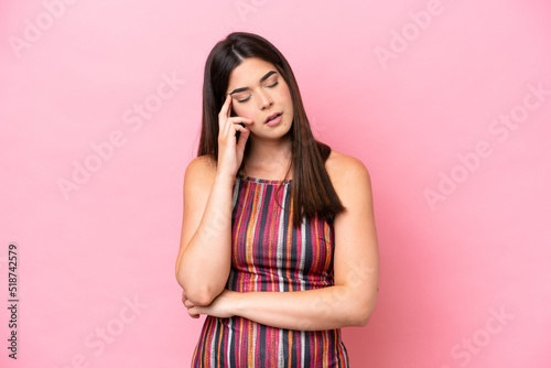Young Brazilian woman isolated on pink background with headache © luismolinero