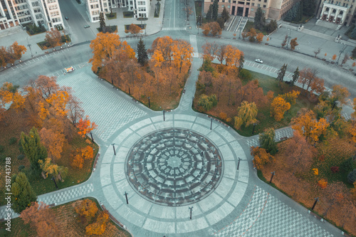 Center of Kharkiv city in peacetime. Square near Derzhprom in Kharkiv in autumn with yellow trees - aerial drone shot.