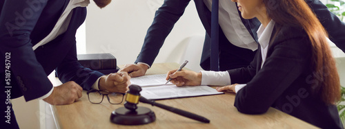 Φωτογραφία Group of lawyers signing papers while working with lawsuit documents