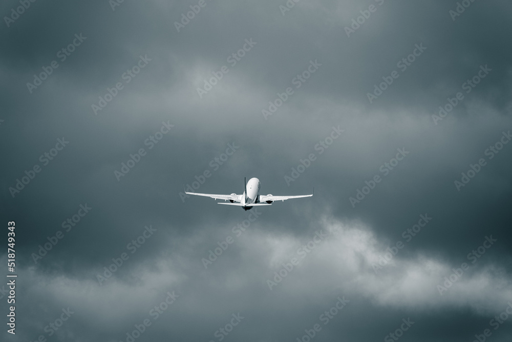 Passenger aircraft flying in the cloudy sky after take off. Heavy cumulonimbus clouds in the flight. Bussiness trip. Adventure and journey concept. Passenger aircraft flying in the cloudy sky after take off. Heavy cumulonimbus clouds in the flight. Bussiness trip. Adventure and journey concept.