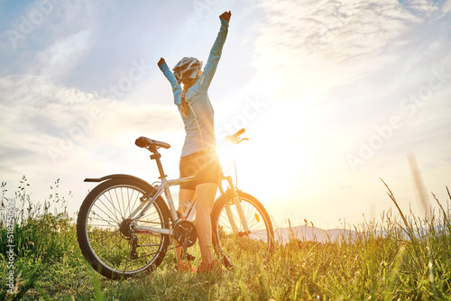 Cyclist Woman riding bike in helmets go in sports outdoors on sunny day a mountain in the forest Fototapet