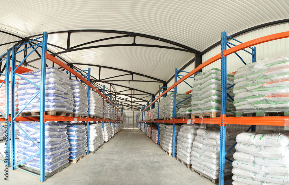 Fototapeta premium Large warehouses of sacks of animal feed. Veterinary production. Animal feed in stock. Pallets with cargo.