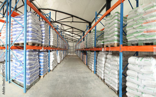 Large warehouses of sacks of animal feed. Veterinary production. Animal feed in stock. Pallets with cargo.