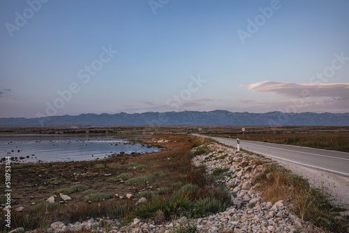 Road and sea bay on Island Pag in Croatia during the sunset