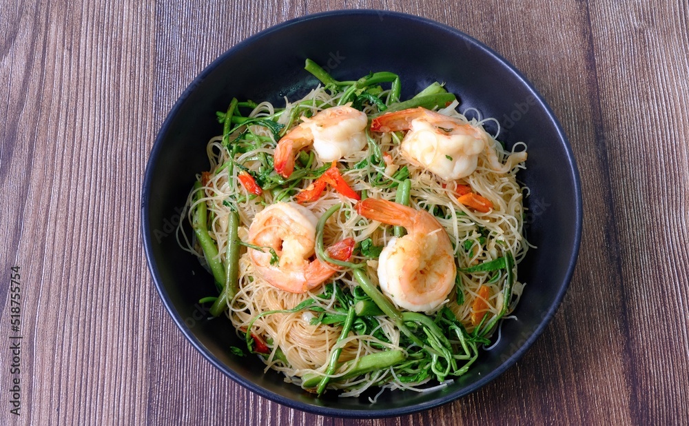 Top view table stir fried rice noodle with shrimp and water minosa vegetable or Mee Phat Krachet Koong in Thai. Top view table stir fried rice noodle with shrimp and water minosa vegetable or Mee Phat Krachet Koong in Thai.