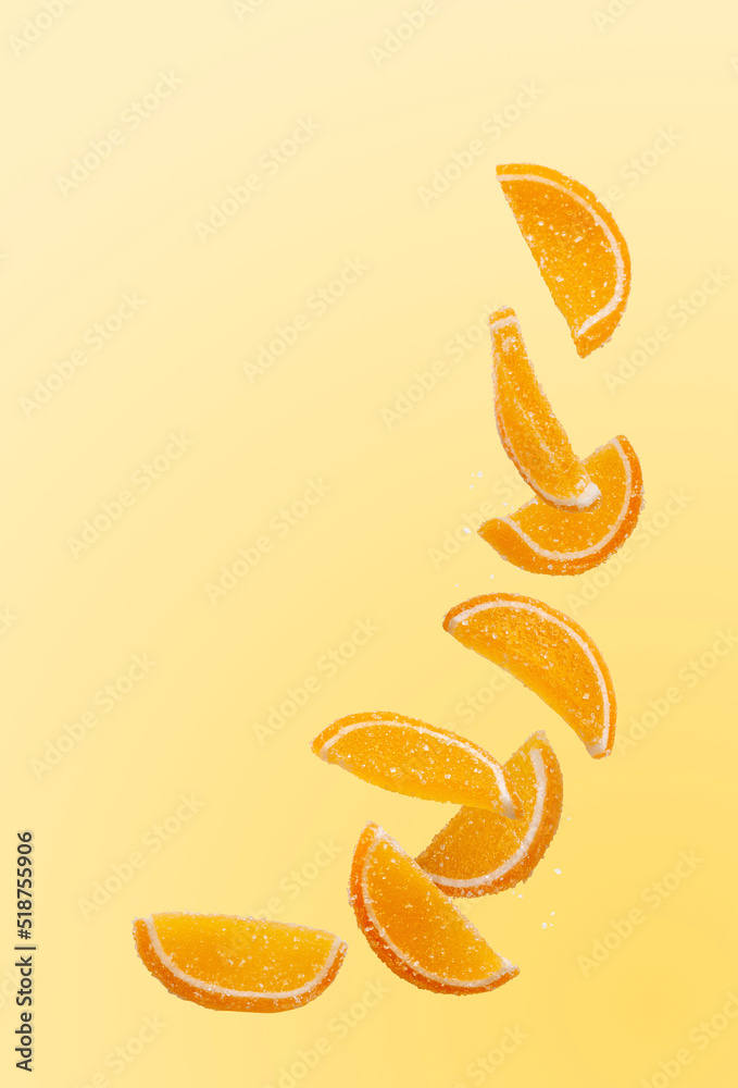 Fototapeta premium slices of orange marmalade fly on a yellow background, copy space