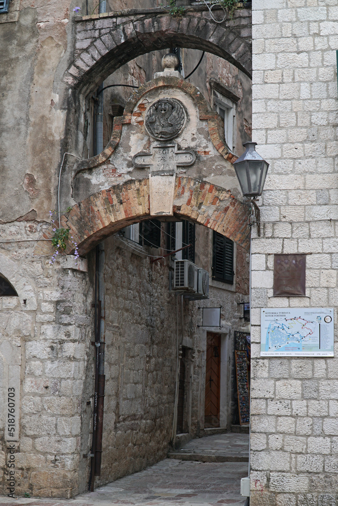 An ancient archway entrance to a quiet street in Kotor, Montenegro